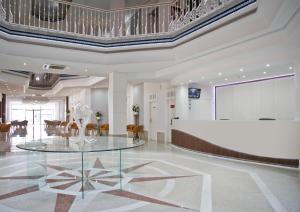 a lobby with a glass table and a podium at Hotel Los Delfines in La Manga del Mar Menor