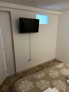a room with a flat screen tv on a wall at La casa di Ginevra in Polignano a Mare