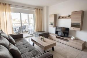a living room with a couch and a coffee table at Cozy 2-bedroom Apartment in Piraeus (ERM_E9) in Piraeus