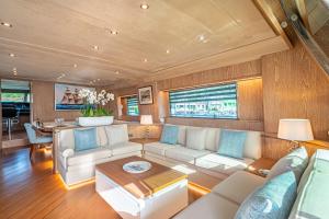 a living room with a couch and a table at M/Y Opera in Sami