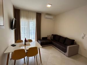 a living room with a couch and a table at APARTMENTS TOMIĆ in Becici