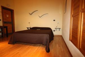 a bedroom with a bed with birds on the wall at Albergo Tripoli B&B Affittacamere in Corato