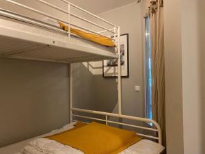 a bedroom with a bunk bed with a yellow blanket on it at Åre Travel- Freestyle in Åre