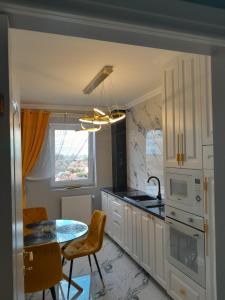 uma cozinha com uma mesa e uma sala de jantar em Luxury Home em Oradea