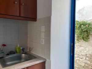 a kitchen with a sink and a counter top at Walk on the beach in seconds - Studio with Apollon beach view balcony in Apollon