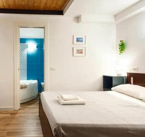 a bedroom with a bed and a tub in a bathroom at Rega Holiday House in Naples