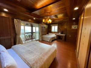 a bedroom with two beds and a window at Emmanuel Farm House in Renai