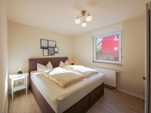 a bedroom with a large bed and a window at Apartment Müritz Ferienpark Röbel-20 by Interhome in Röbel