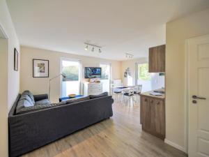 a living room with a couch and a kitchen at Apartment Müritz Ferienpark Röbel-20 by Interhome in Röbel