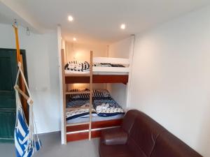 a room with bunk beds in a room with a couch at Studio Vodopády Černá Desná by Interhome in Desná