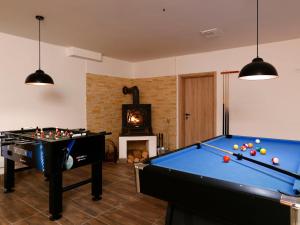 a living room with a pool table and a fireplace at Studio Vodopády Černá Desná by Interhome in Desná +23 photos