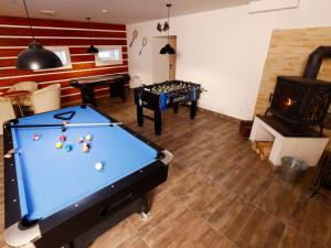 a living room with a pool table and a fireplace at Apartment Hora Jizera by Interhome in Desná