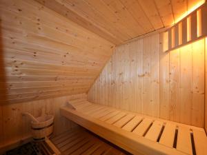 a small wooden sauna with a bucket in it at Apartment Müritz Ferienpark Röbel-21 by Interhome in Röbel