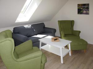 a living room with two chairs and a couch and a table at Apartment Müritz Ferienpark Röbel-21 by Interhome in Röbel