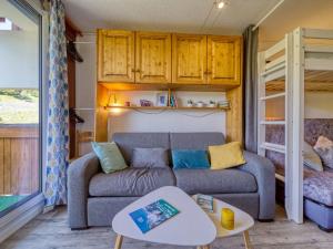 a living room with a couch and a bunk bed at Studio Soyouz Vanguard-97 by Interhome in Le Corbier