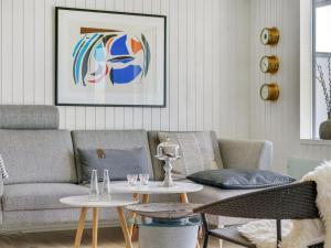 a living room with a couch and a table at Apartment Tarvo - 500m from the sea in NW Jutland by Interhome in Pandrup