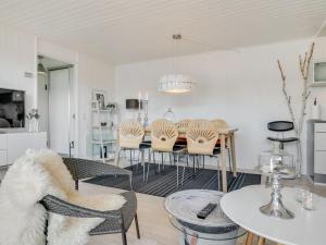 a living room with a table and chairs at Apartment Tarvo - 500m from the sea in NW Jutland by Interhome in Pandrup +23 photos