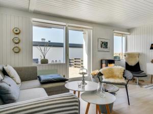 a living room with a couch and two chairs at Apartment Tarvo - 500m from the sea in NW Jutland by Interhome in Pandrup