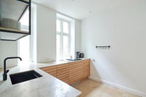 a kitchen with a sink and a large window at Spacious 3 Bedroom Manor Flat Next to Tivoli in Copenhagen