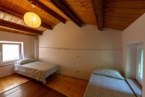 מיטה או מיטות בחדר ב-Relais Castel d'Emilio - Casa BLU