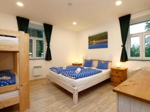 a bedroom with two bunk beds and two windows at Apartment Přehrada Souš by Interhome in Desná