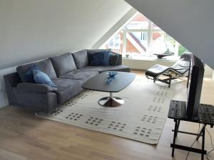 a living room with a couch and a table at Apartment Rosabel - 1km from the sea in NW Jutland by Interhome in Skagen