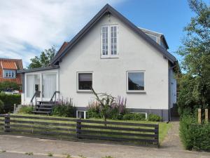 a white house with a black roof at Apartment Rosabel - 1km from the sea in NW Jutland by Interhome in Skagen
