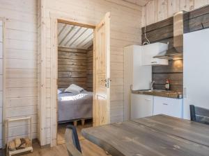 a room with a bed and a kitchen with a table at Holiday Home Isoporo d by Interhome in Saariselka