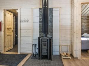 a wood stove in a room with a bedroom at Holiday Home Isoporo d by Interhome in Saariselka