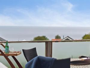 a patio with a table and chairs on a balcony at Holiday Home Dika - 400m from the sea in Bornholm by Interhome in Hasle