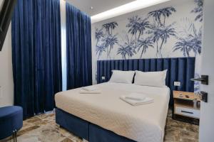 1 dormitorio con 1 cama grande con cortinas azules en La Maison Boutique Hotel, en Ksamil