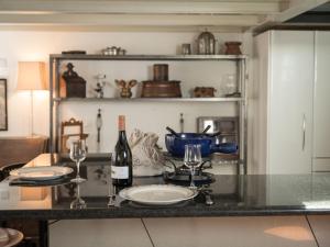 a table with two glasses and a bottle of wine at Apartment Villa Emanuel by Interhome in Zermatt