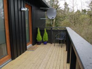 a balcony of a house with a table and a chair at Holiday Home Jonce - 250m from the sea in Sealand by Interhome in Vejby