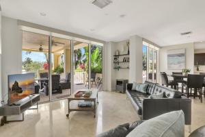 a living room with a couch and a tv at Coastal Condo Deerfield Beach Retreat 3 bed 2 bath in Deerfield Beach
