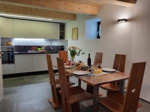 a dining room with a wooden table and chairs at Holiday Home Cà dal Leo by Interhome in Bignasco