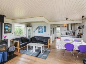 a living room with a couch and a table at Holiday Home Eliene - 400m from the sea in Bornholm by Interhome in Hasle