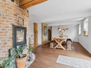 a living room with a brick wall and a fireplace at Apartment Erich - 200m from the sea in Bornholm by Interhome in Hasle