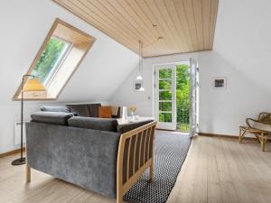 sala de estar con sofá y ventana en Holiday Home Rina - 250m from the sea in Bornholm by Interhome, en Hasle