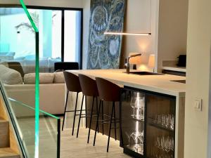 a kitchen with a counter with bar stools at Villa Cristina in Nerja