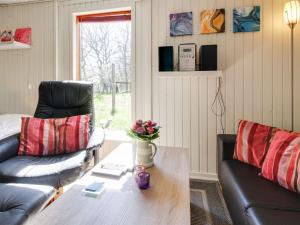 a living room with two couches and a table at Apartment Kolja - 3km from the sea in Western Jutland by Interhome in Blåvand