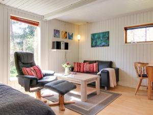 a living room with two chairs and a table at Apartment Kolja - 3km from the sea in Western Jutland by Interhome in Blåvand