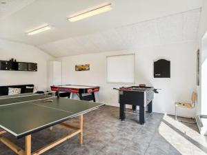a ping pong room with two ping pong tables at Holiday Home Josina - 675m from the sea in Sealand by Interhome in Tjørneholm