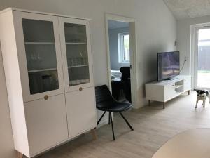 a living room with a white cabinet and a dog at Apartment Esger - all inclusive - 900m from the sea by Interhome in Blåvand