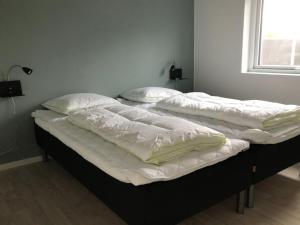 two twin beds in a room with a window at Apartment Esger - all inclusive - 900m from the sea by Interhome in Blåvand