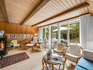 a living room filled with furniture and a fireplace at Holiday Home Sisko - 800m from the sea in Western Jutland by Interhome in Vejers Strand