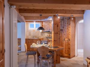 une cuisine avec une grande table et des chaises en bois dans l'établissement Apartment Chesa Anemona al Lej by Interhome, à Saint-Moritz