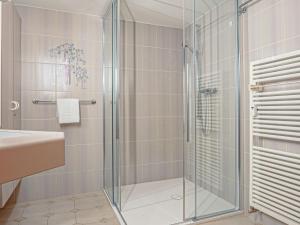 een badkamer met een glazen douche en een wastafel bij Apartment Chesa Anemona al Lej by Interhome in St. Moritz