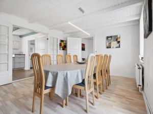 a kitchen and dining room with a table and chairs at Holiday Home Essie - 20km from the sea in Western Jutland by Interhome in Agerskov