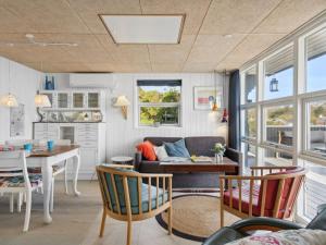 a kitchen and living room with a table and chairs at Holiday Home Steen - 30m from the sea in Funen by Interhome in Vejstrup