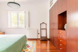 a bedroom with a bed and a wooden dresser at Casal das Aveleiras in Cartaxo +77 photos